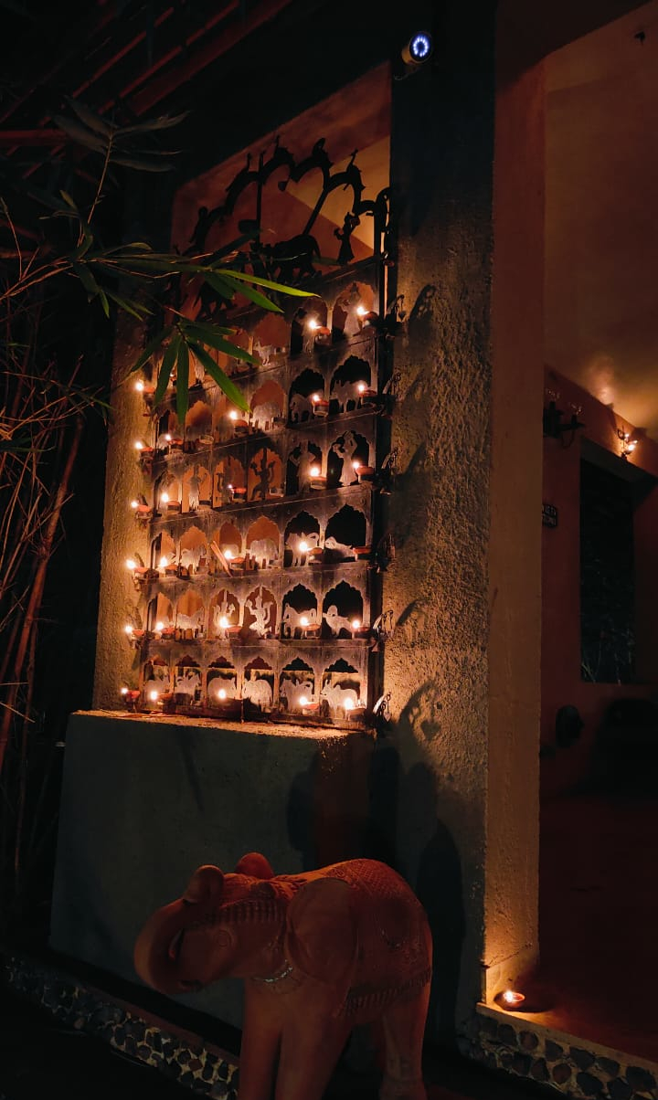 Candlelit dining hall with long teak tables