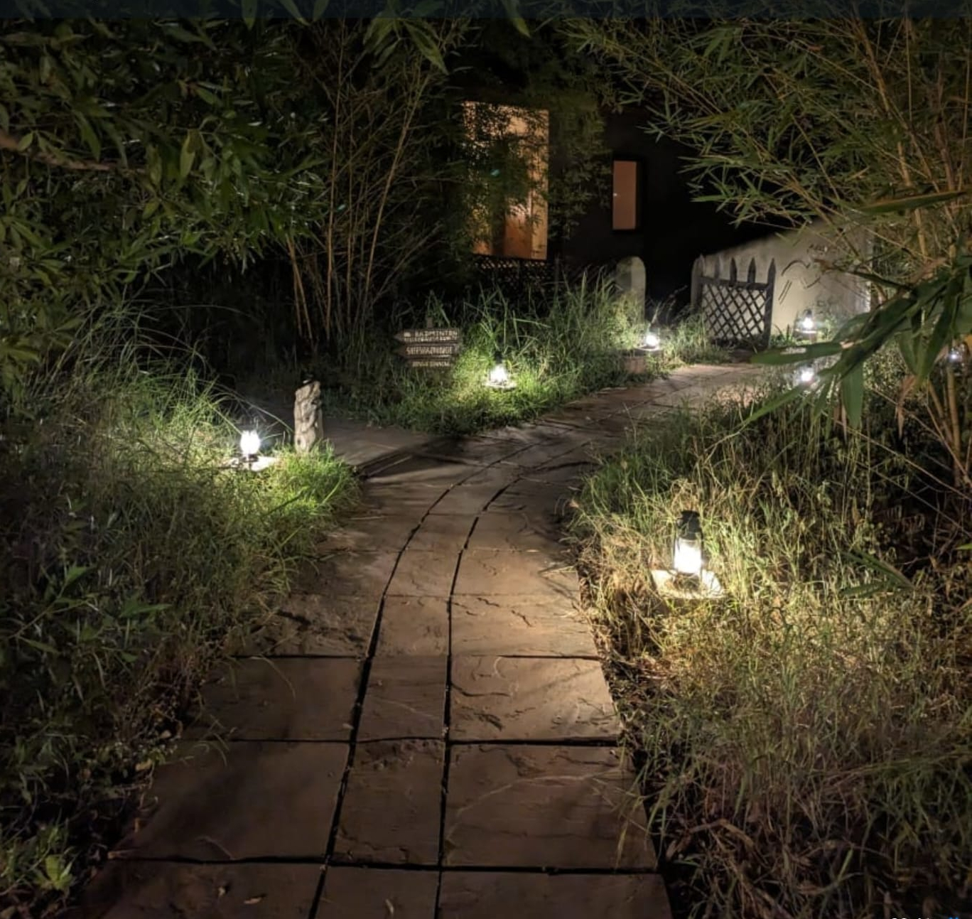 Cottage exterior opening onto the stone walkway and garden